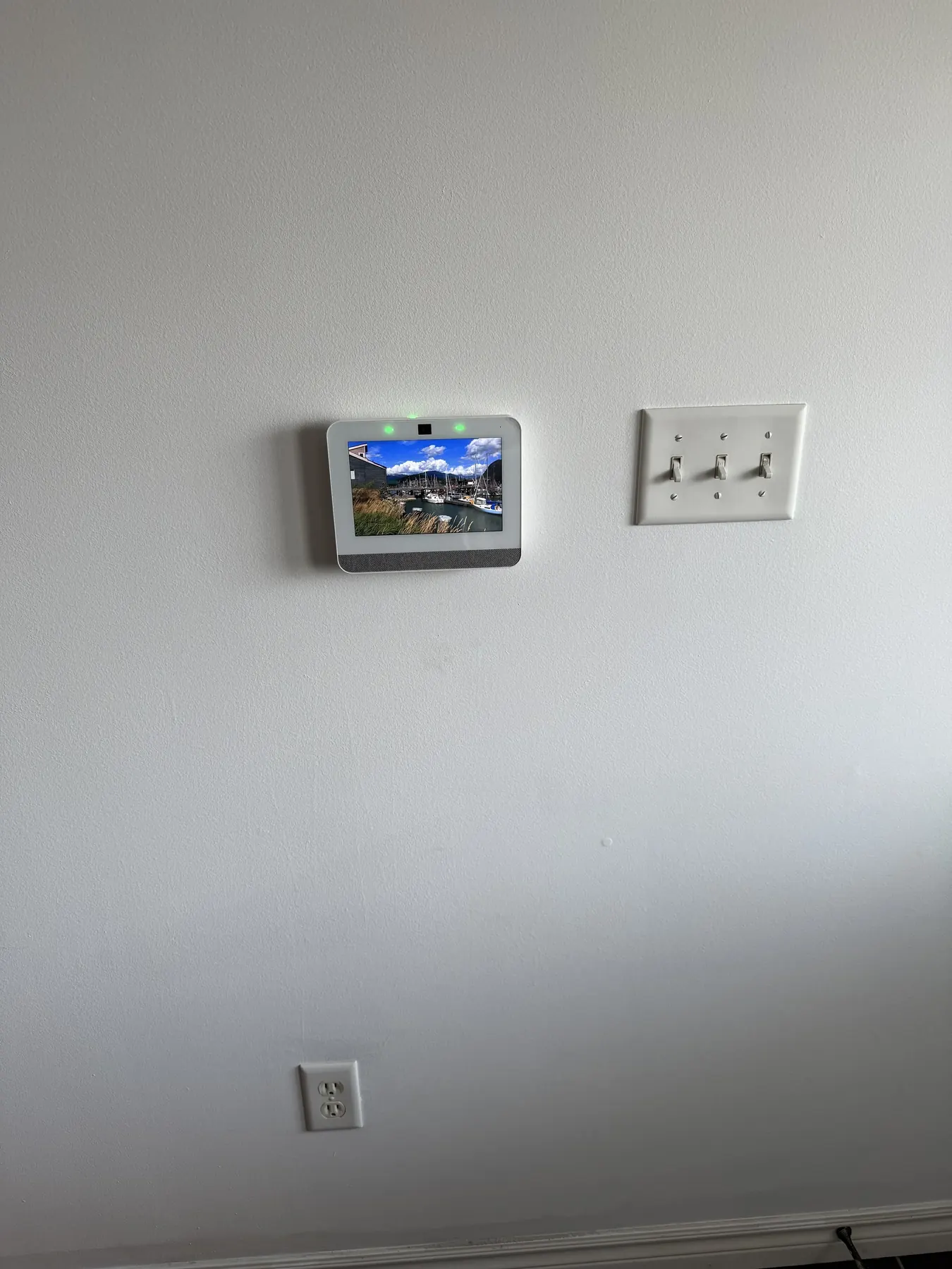 Alarm keypad panel installed flush on a finished hallway wall