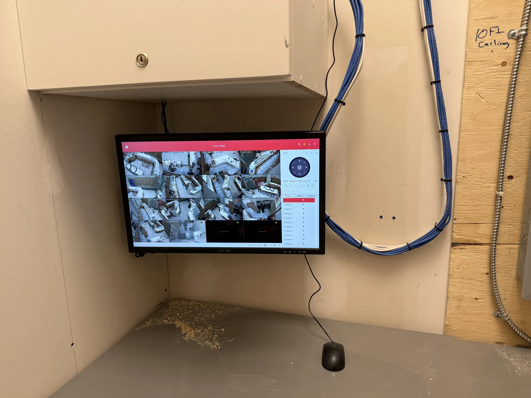 Wall mounted monitor showing live camera views in a back room